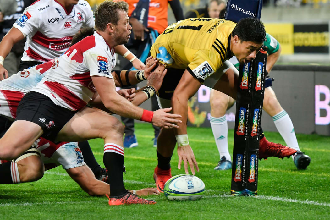 Hurricanes' winger Ben Lam scores one of his three tries against the Lions in his team's Super Rugby win.