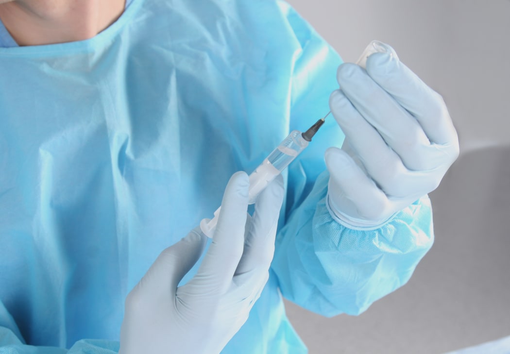 Syringe, medical injection in hand, palm or fingers.