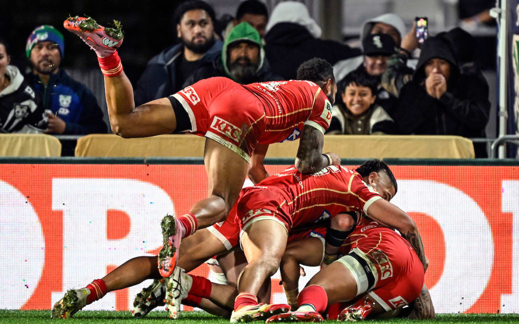 Dolphins players celebrate a try by Jamayne Isaako.
