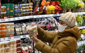 A woman checking the price of food at a Moscow supermarket. (File photo)