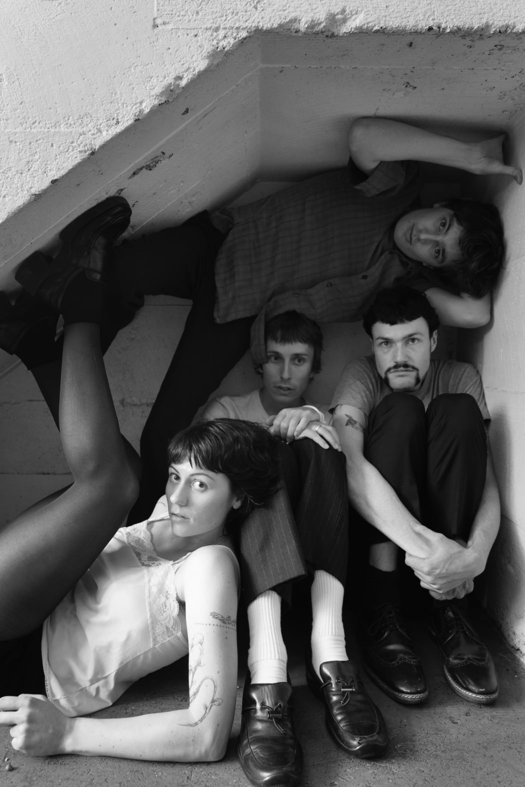 The Auckland post-punk band Ringlets sit crowded into a cubby-hole together.