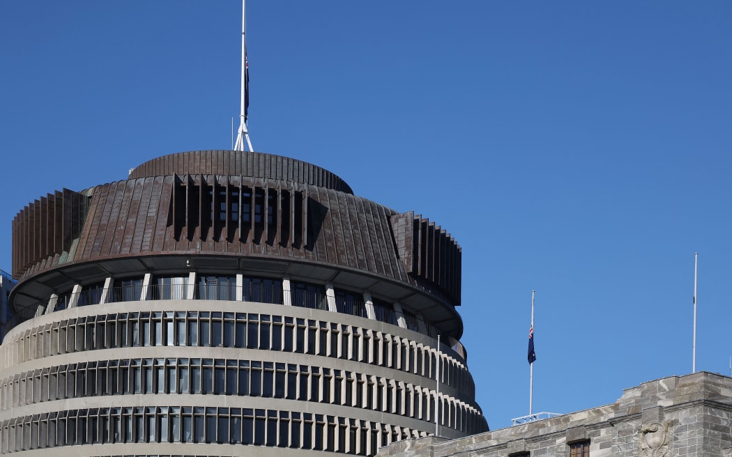 The New Zealand flags on the roof of Parliament buildings sit at half mast after the death of the Queen in Wellington on September 9, 2022.  (Photo by Marty MELVILLE / AFP)