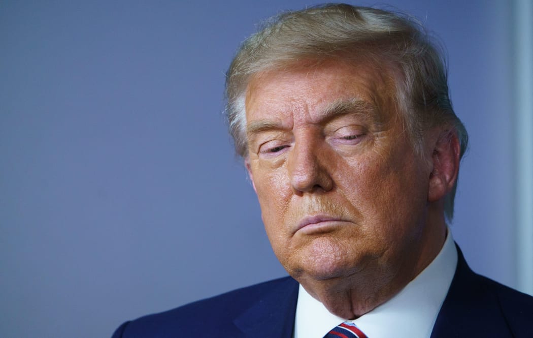 US President Donald Trump looks down during an event on lowering prescription drug prices in the Brady Briefing Room of the White House in Washington, DC on November 20, 2020.