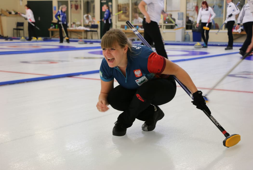 Polish skip Marta Pluta in full cry after releasing a stone