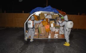 As part of the Marshall Islands' Covid-19 prevention strategy, an Environmental Protection Authority team sprays incoming cargo at Amata Kabua International Airport.