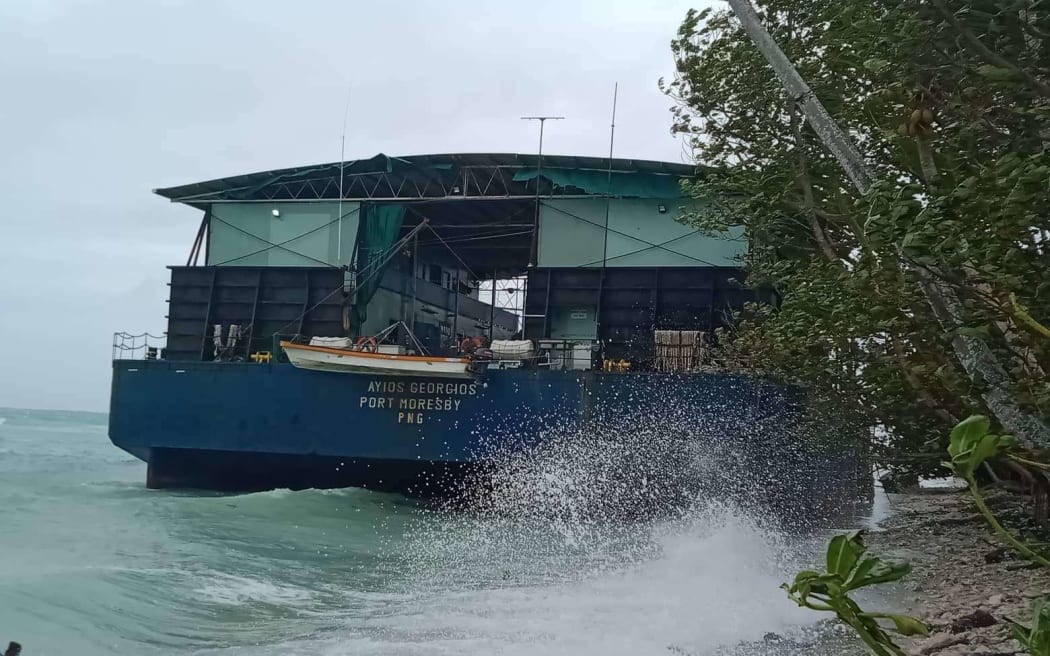 A barge that was moored in Funafuti lagoon was shunted onto the beach by Cyclone Tino.