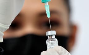 A health worker prepares an injection of the Pfizer-BioNTech vaccine against the coronavirus at a vaccination centre, set up at the Dubai International Financial Centre.