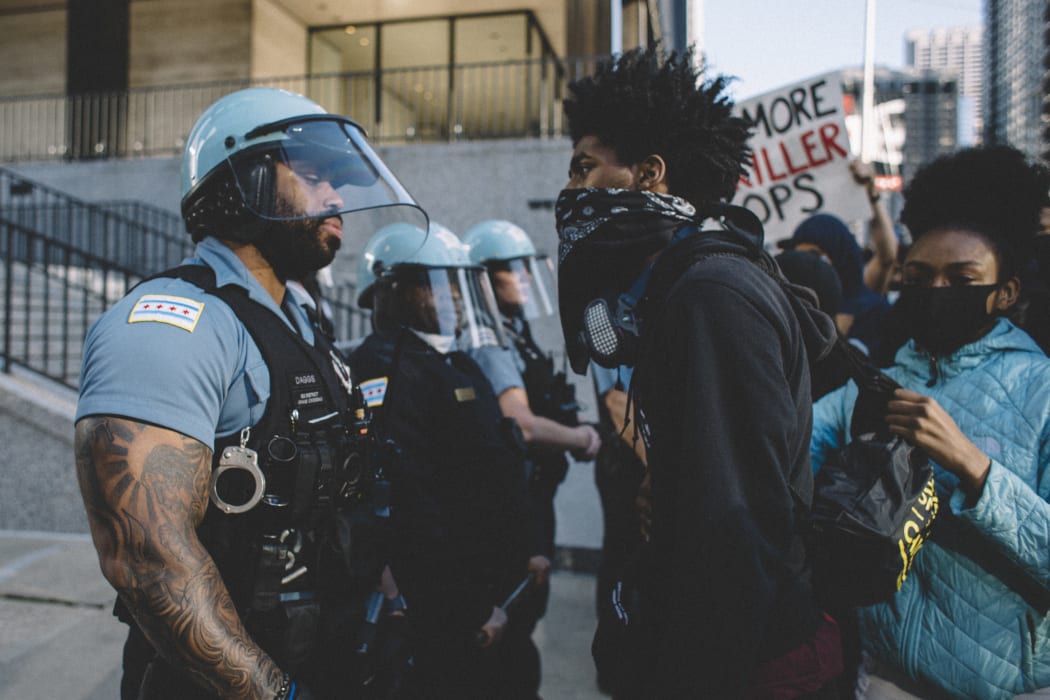 Protesters clash with police in Chicago  , on May 30, 2020 during a protest against the death of George Floyd, an unarmed black man who died while while being arrested and pinned to the ground by the knee of a Minneapolis police officer.