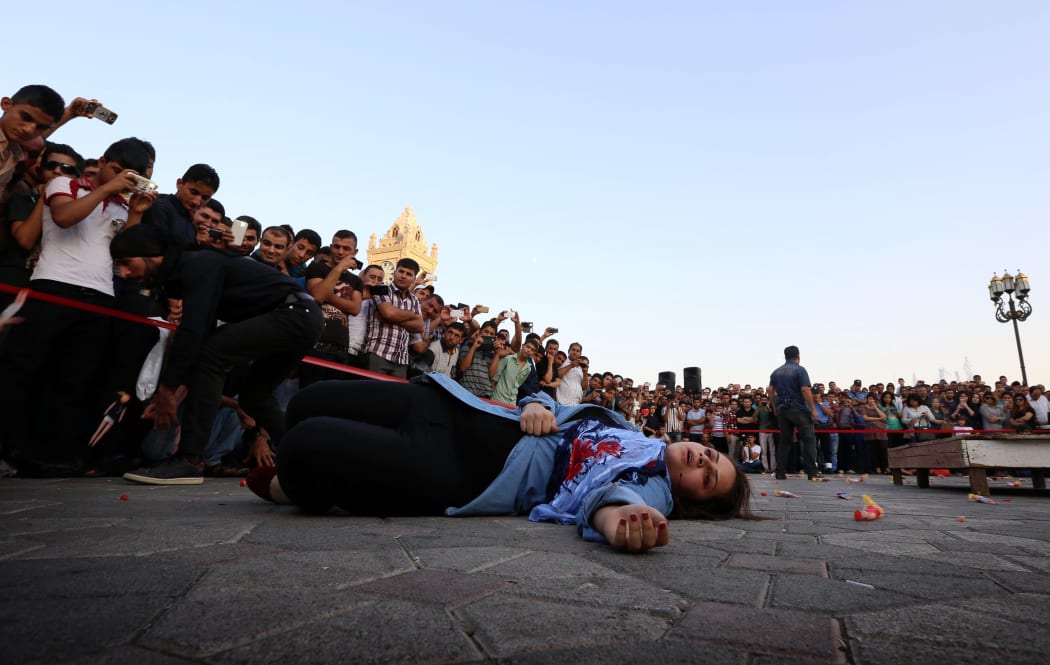 An Iraqi Kurdish actress performs in a play denouncing the threat of the Islamic State, in Arbil, the capital of the autonomous Kurdish region of northern Iraq.