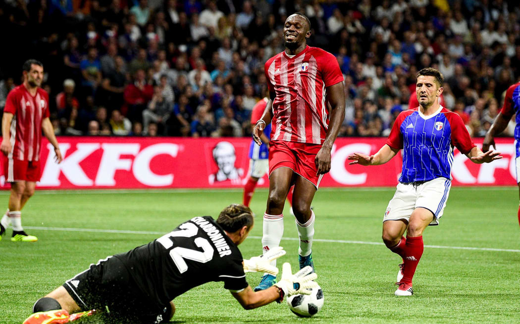 Usain Bolt playing football.