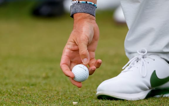 Golf ball being teed up.