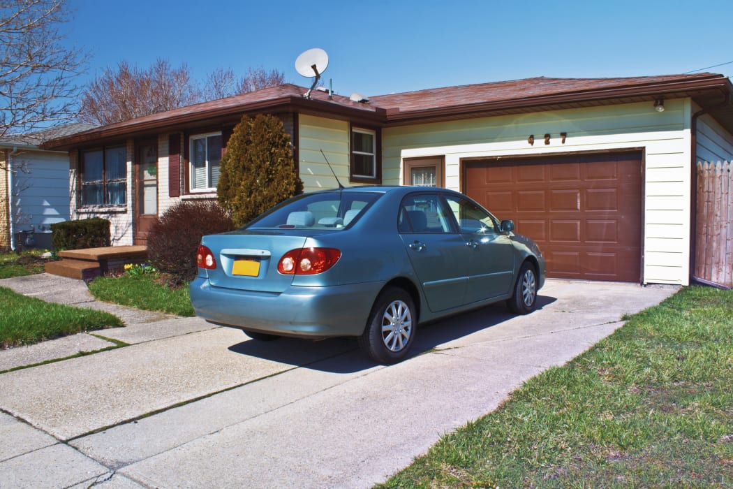 A car in front of a garage.