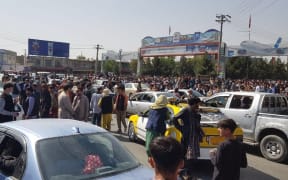 Afghans crowd at the tarmac of the Kabul airport.