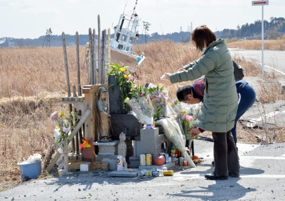 A couple at a shrine near the stricken nuclear plant on the third anniversary of the disaster.