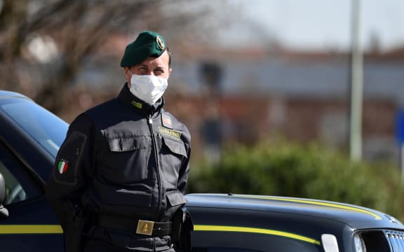 Italian police officer at a checkpoint at the small town of Zorlesco, southeast of Milan, on February 26, 2020.