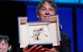 Sean Baker holds the Palme d'Or for the film 'Anora,' during the awards ceremony of the 77th international film festival, Cannes, southern France, Saturday, May 25, 2024 (Photo by Andreea Alexandru/Invision/AP)