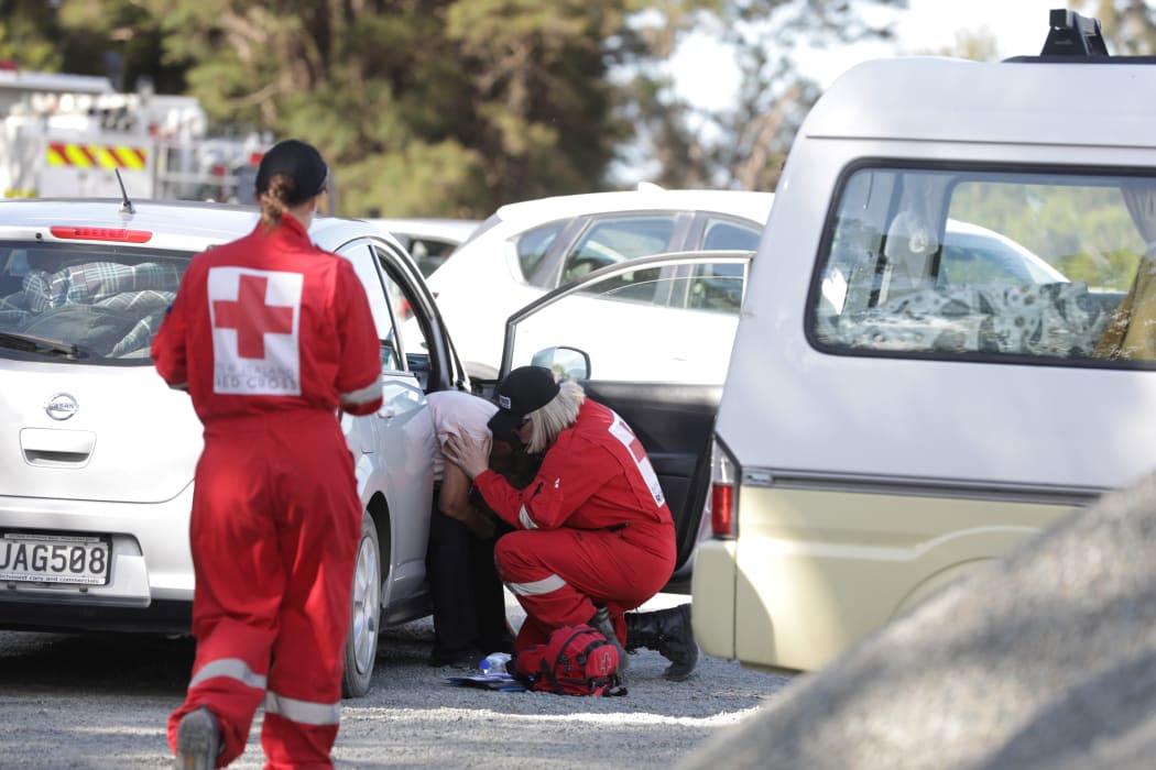 Red Cross workers help a woman who was evacuated from Teapot Valley.