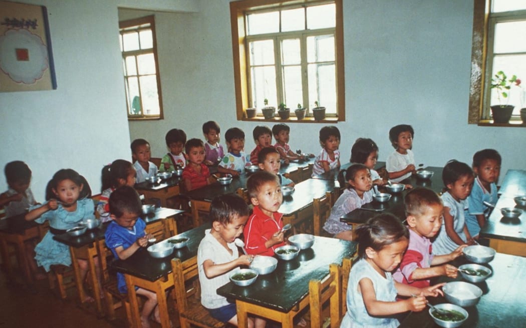 North Korean children receive UN food rations in a village northwest of Pyongyang in 1997, during the country's devastating famine.