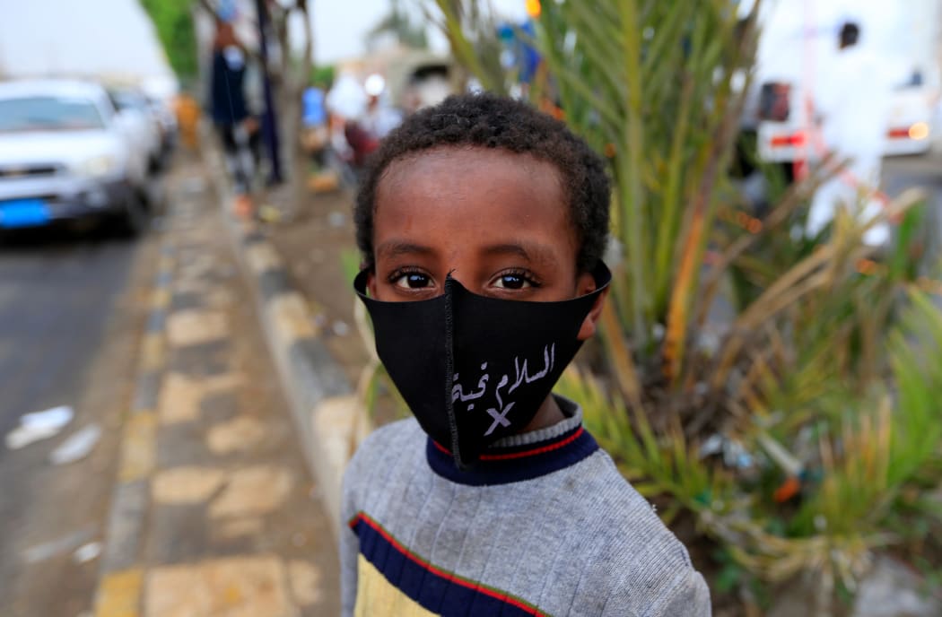 A Yemeni boy wearing a protective face mask is pictured in the capital Sanaa, during the ongoing novel coronavirus pandemic crisis.