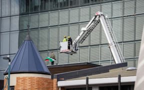 A person climbed onto the roof of the Christchurch City Council during a pro-Palestine protest on 13 May 2024.