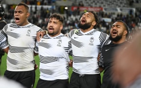 Fiji players sing after playing the All Blacks.