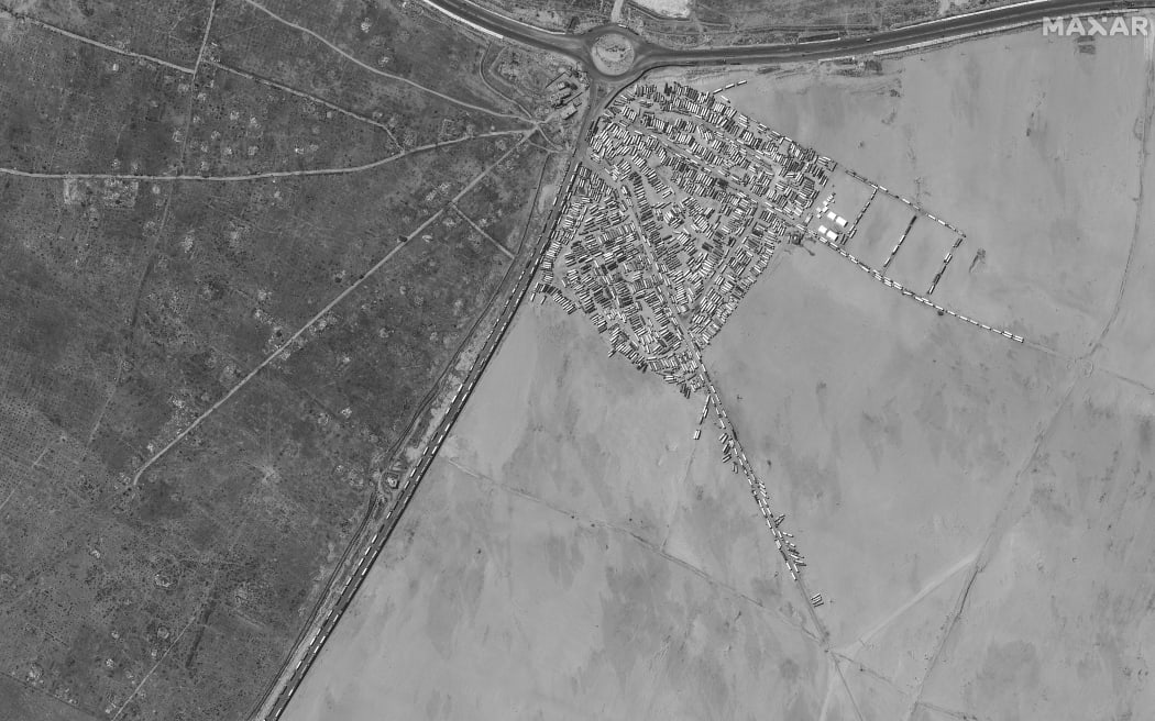 This handout image courtesy of Maxar Technologies taken by the WorldView-1 satellite on May 7, 2024 shows an aerial view of cargo trucks relocated away from the Rafah border crossing with Egypt in the southern Gaza Strip amid the ongoing conflict in the Palestinian territory between Israel and Hamas.