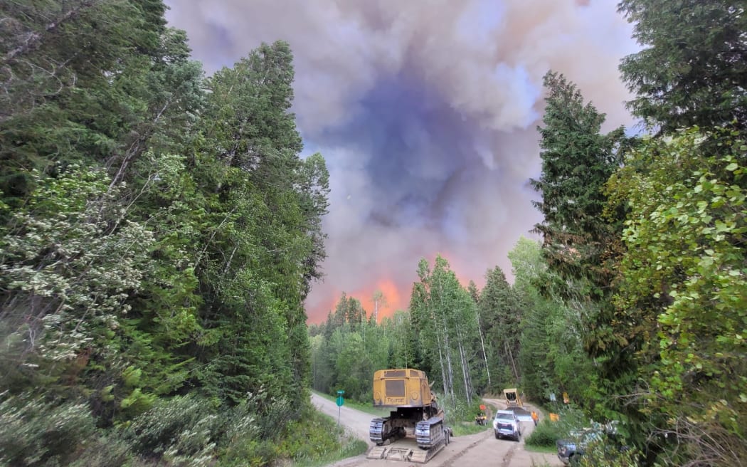 Smoke plumes cover the air as firefighters battle flames in Canada.