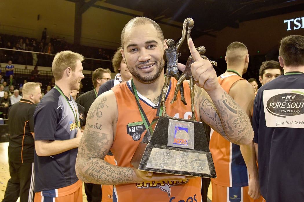 Kevin Braswell captain of the Southland Sharks holds the NBL trophy after winning the final.