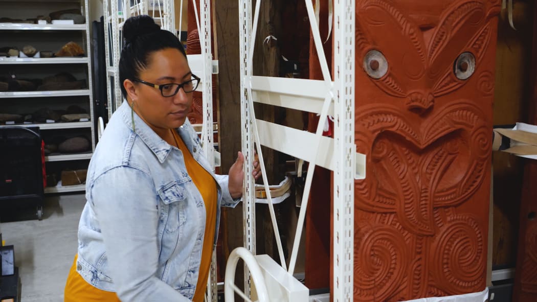 Hikitia Harawira, Collection Manager Taonga Māori arranging whakairo (carving) in the Auckland Museum storeroom.