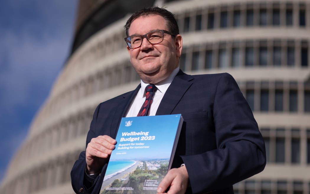 Finance minister Grant Robertson showing the cover of Budget 2023 the day before its reveal