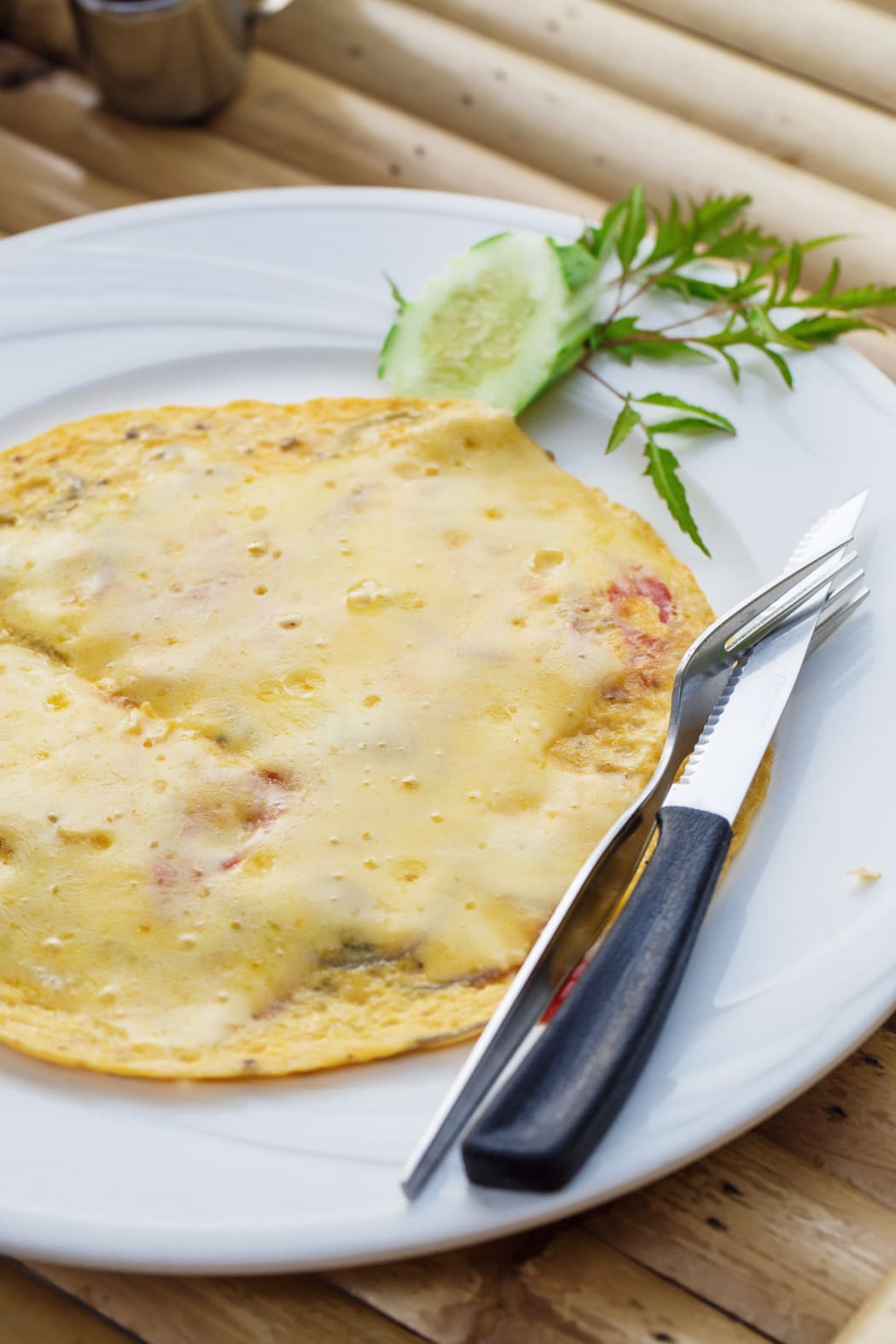Cheese omelette with cucumber on a plate