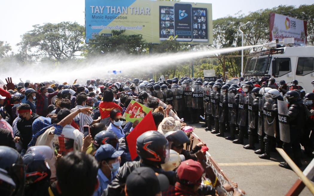 Police fire water cannon at protesters as they demonstrate against the 1 February   military coup in the capital Naypyidaw, 9 February, 2021.