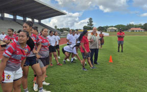 Prime Minister Christopher Luxon gets on the rugby field with some young female players in Tonga, while attending the Pacific Islands Forum leaders meeting.