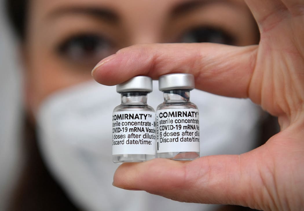 Topic picture - vaccination with the Comirnaty mRNA vaccine from BionTech Pfizer. Vaccine doses with vaccine for injection with a cannula. Close up.