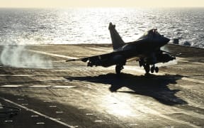 A French Rafale fighter aircraft lands aboard the French Charles-de-Gaulle aircraft carrier