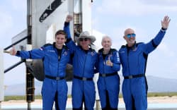 Blue Origin’s New Shepard crew (L-R) Oliver Daemen, Jeff Bezos, Wally Funk, and Mark Bezos pose for a picture near the booster after flying into space in the Blue Origin New Shepard rocket on 20 July 20, 2021 in Van Horn, Texas.