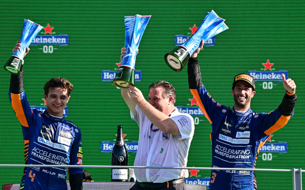 (fromL) Second-placed Lando Norris, Chief Executive Officer of the McLaren Zak Brown and winner Daniel Ricciardo celebrate during the podium ceremony after the Italian Formula One Grand Prix at Monza, on September 12, 2021.