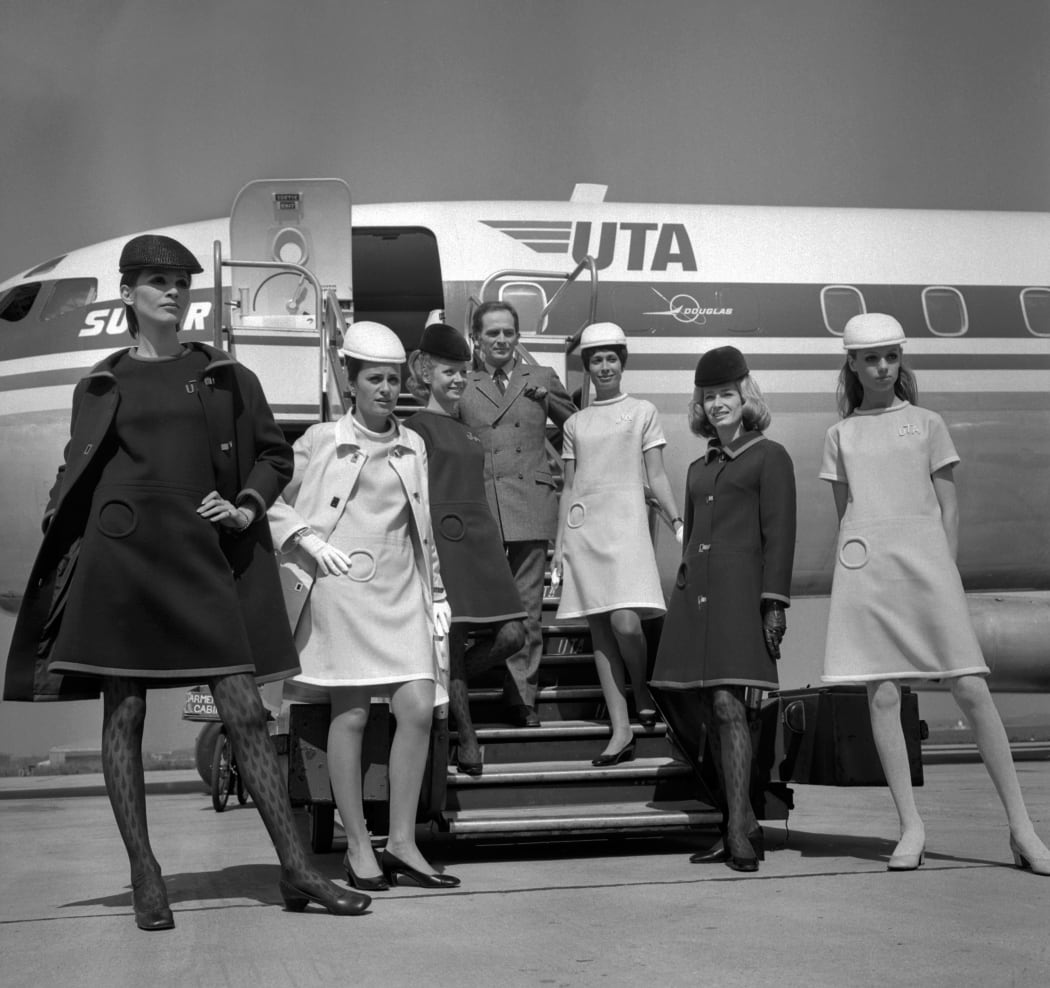 French designer Pierre Cardin presenting the new uniforms of UTA's flight attendants, at Le Bourget airport on May 9, 1968.