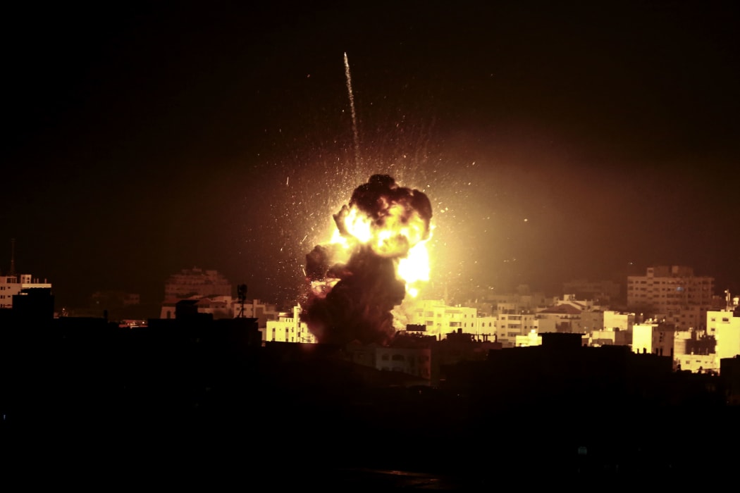 A ball of fire rises above a building believed to house the offices of Hamas political chief in Gaza, Ismail Haniyeh, during strikes carried out by the Israeli army in retaliation for a rocket that damaged a house, injuring seven people.