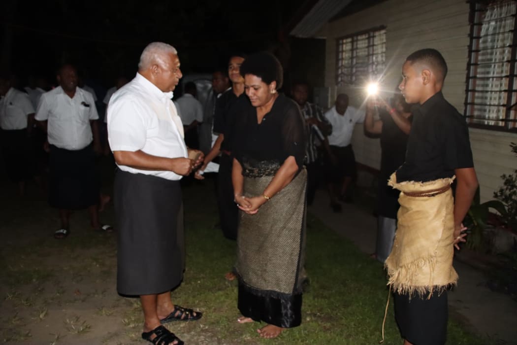 Fijian Prime Minister Frank Bainimarama meets the family of the late Ratu Serufoama Savu Dakuna following the funeral service in Suva on 5 January.