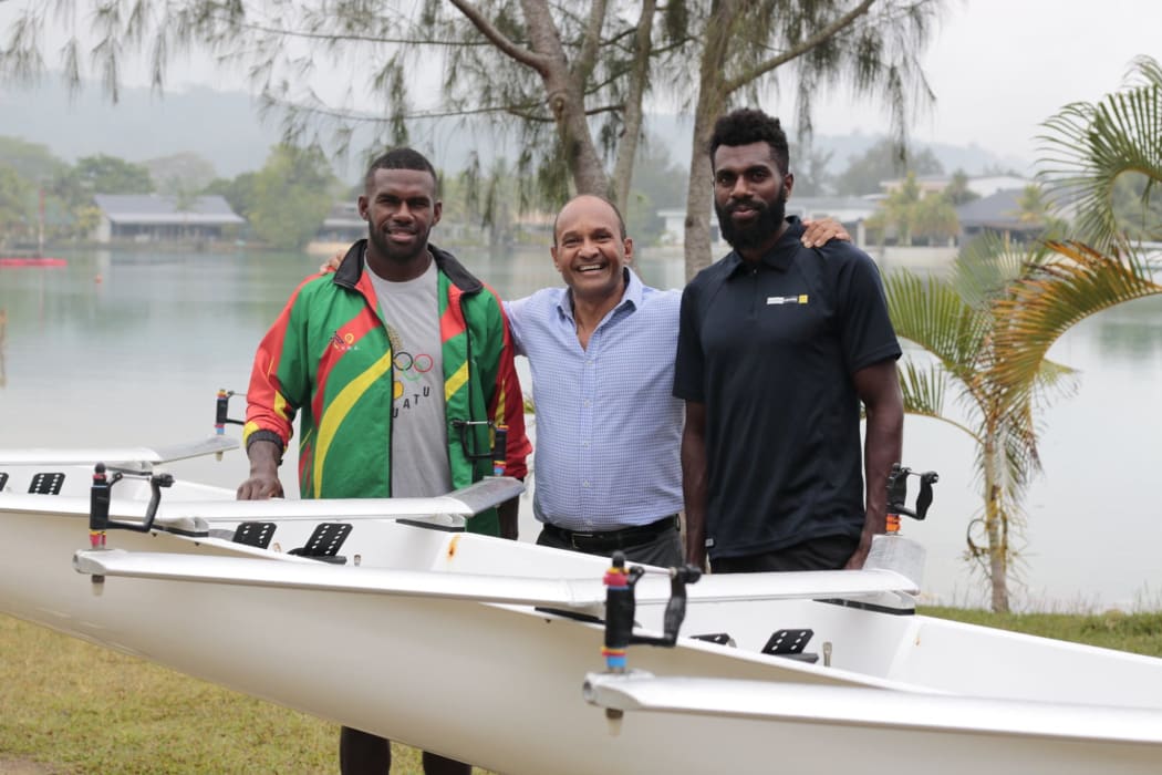 Vanuatu's Minister for Sport Francois Chani Tabisal (c) with rowers Rillio Rio Rii and Luigi Teilemb.