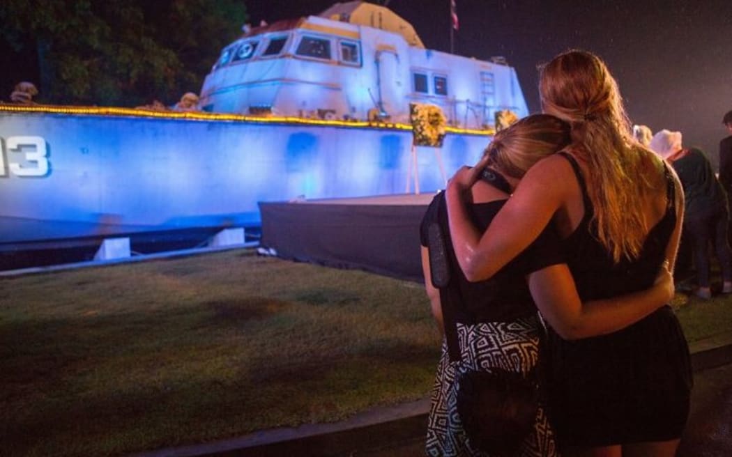 Two tourists comfort each other during a memorial service to mark the tenth anniversary of the Indian Ocean tsunami, in Phang-nga province.