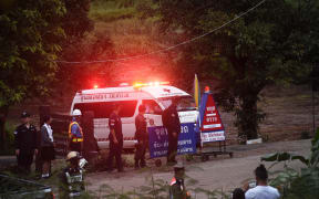 An ambulance leaves the Tham Luang cave area.