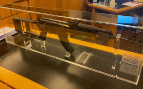 In court, Shane Conza identified this semi-automatic Norinco in a glass case - similar to an AK-47 - as the one he had helped Eli Epiha to bury.