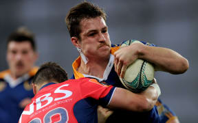 Michael Collins of Otago looks to break the Tasman defence.