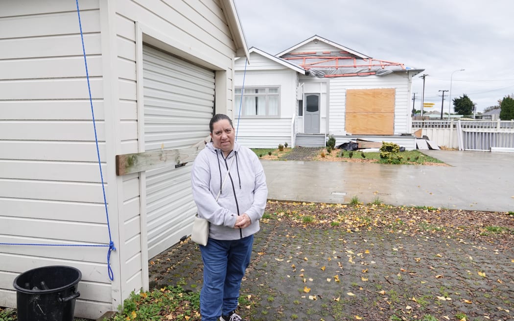 Maren Preston's Wereroa Road home was largely unscathed, but her neighbours weren't so lucky, as the damage to the house in the background shows.