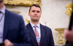 Charlie Kirk stands in the back of the room as US President Donald Trump speaks during a swearing in ceremony for interim U.S. Attorney for Washington, D.C. Jeanine Pirro in the Oval Office of the White House on May 28, 2025 in Washington, DC. Trump has announced Pirro, a former Fox News personality, judge, prosecutor, and politician, after losing support in the Senate for his first choice, Ed Martin, over his views on the January 6, 2021 attack on the U.S. Capitol.   Andrew Harnik/Getty Images/AFP (Photo by Andrew Harnik / GETTY IMAGES NORTH AMERICA / Getty Images via AFP)