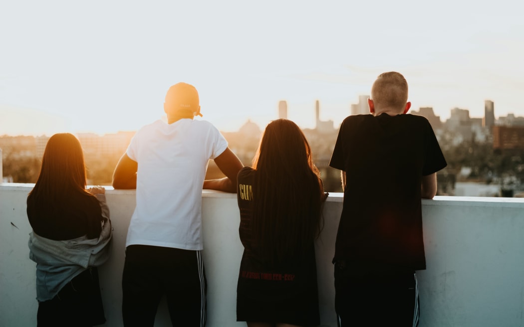 Four young people looking at a sunset