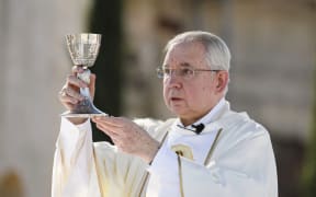 Conservative Archbishop of Los Angeles Jose H Gomez prepares Holy Communion.