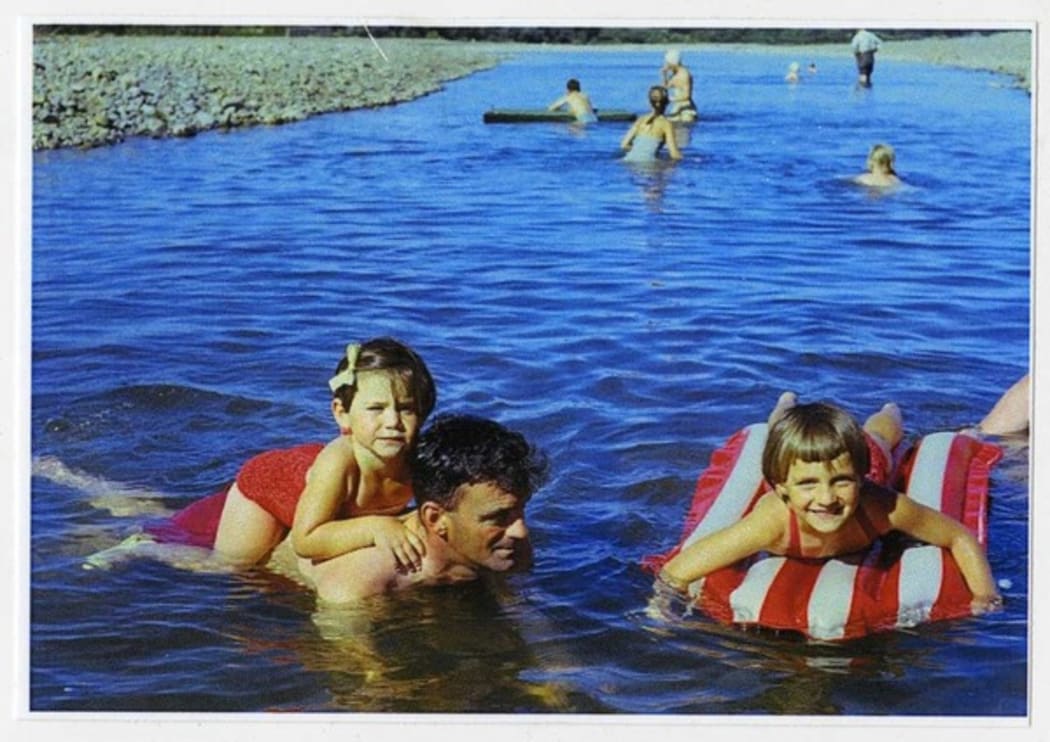 Family in blue clear water